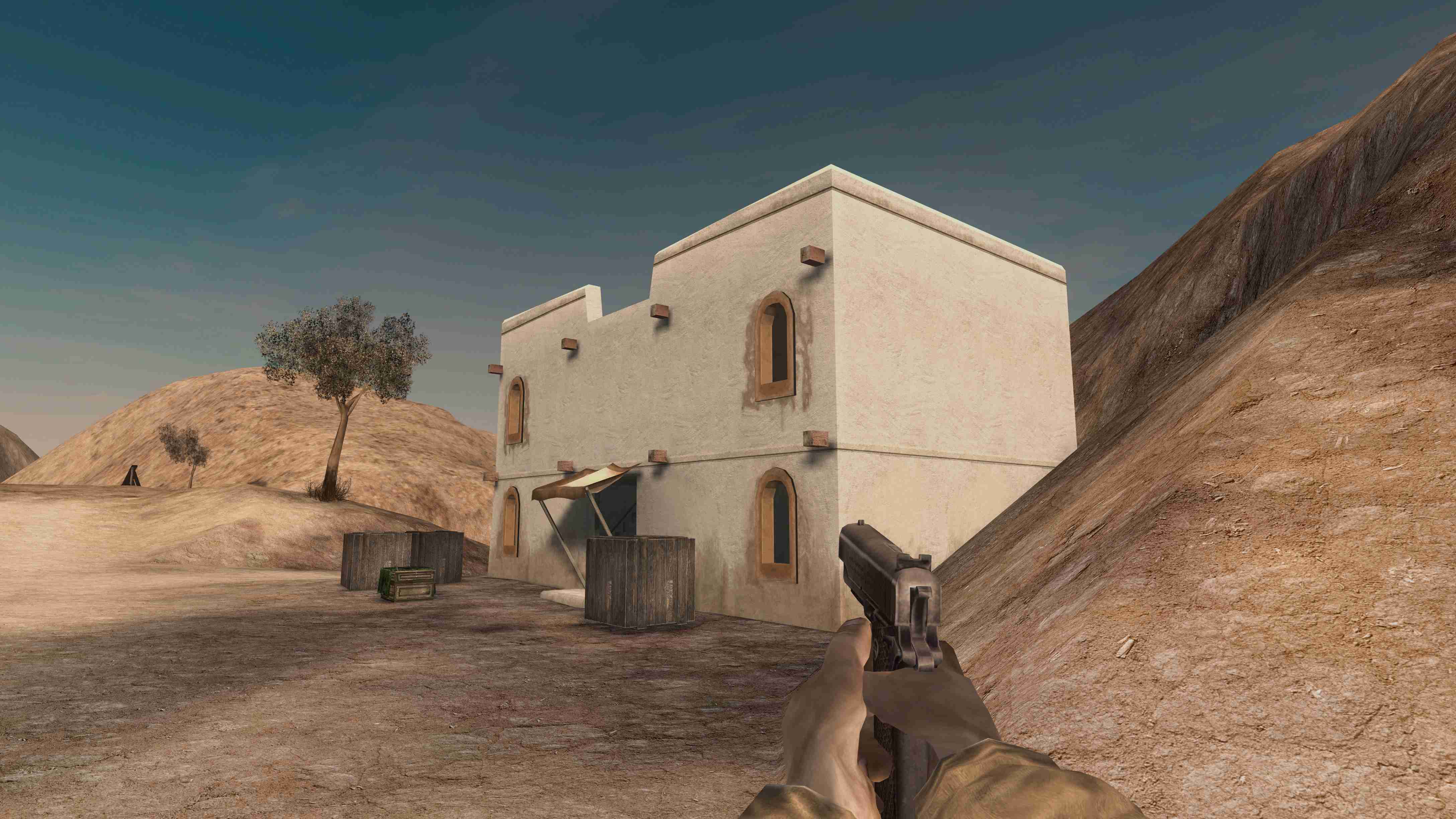Player looking at a white stone house in desert terrain.