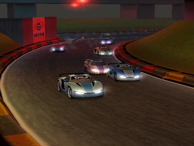 Photo taken from side of racetrack with six cars racing.
